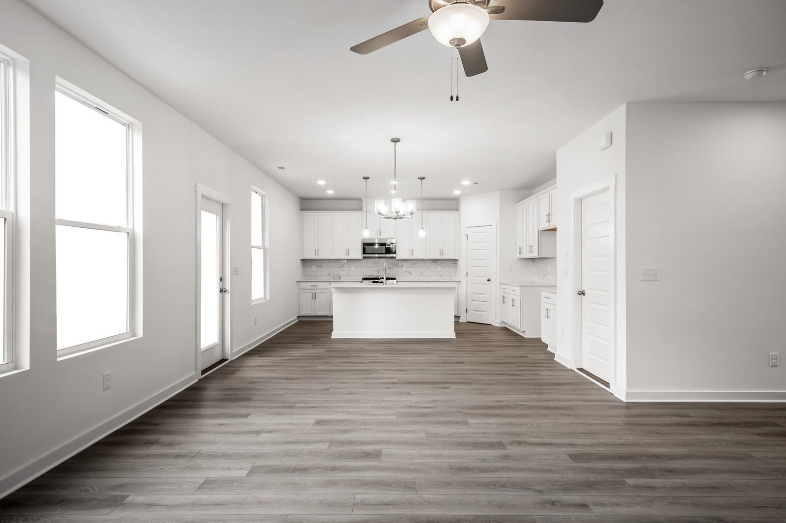 Bright open-concept kitchen and living area in The Logan C floor plan at Calista Farms, White House, Tennessee.