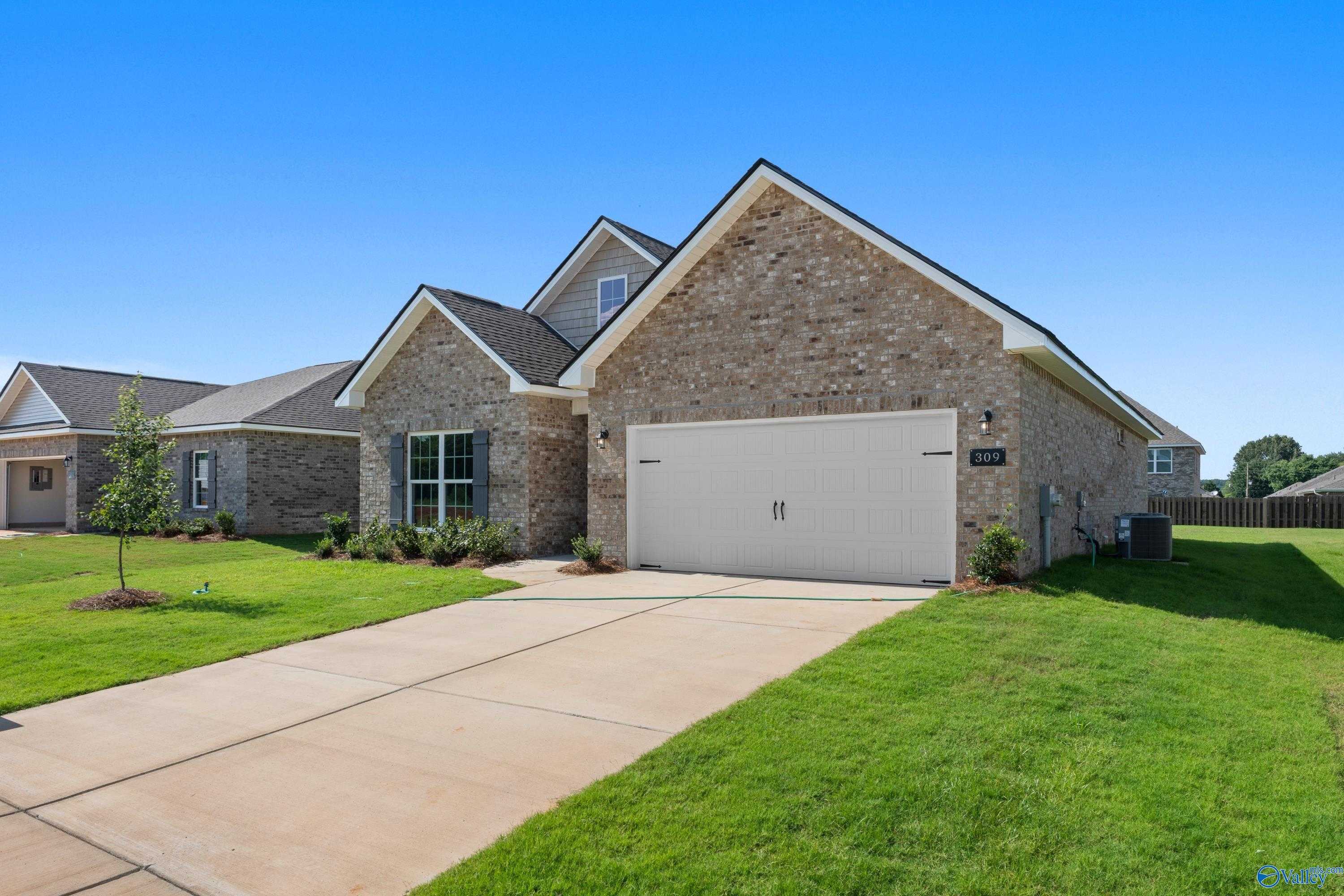 Brick single-story The Franklin C home with 2-car garage, driveway, and green lawn in Clearview, Hazel Green, Alabama by Davidson Homes