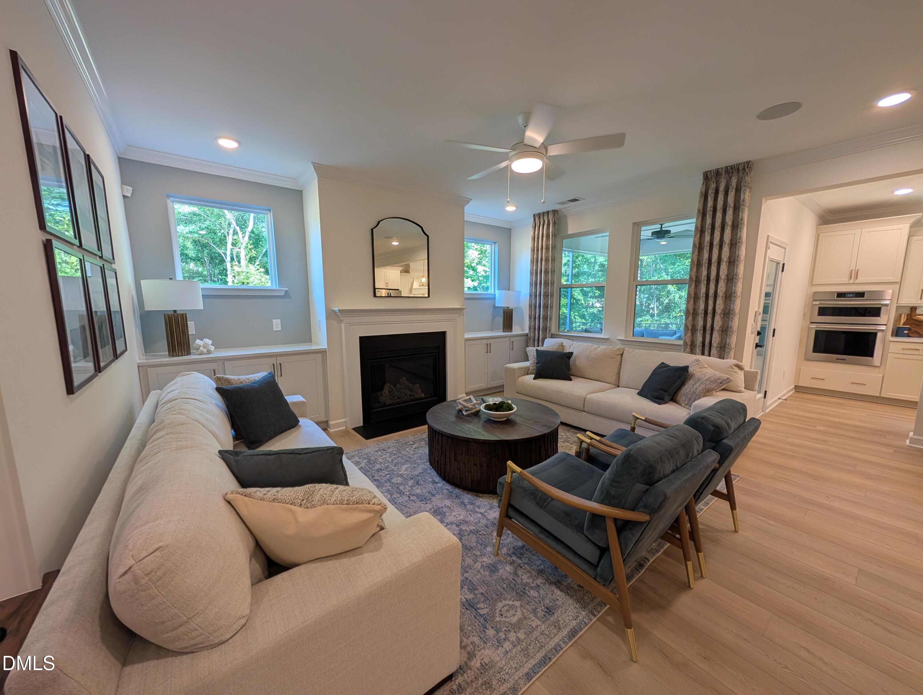 Spacious open-concept living room with fireplace in The Aspen B floor plan at Wendell Ridge in Wendell, North Carolina.