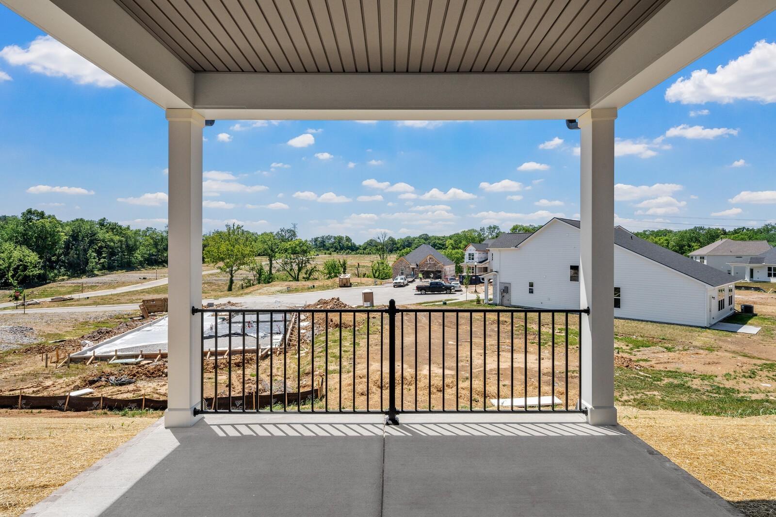 Covered patio view of neighborhood construction in Woods Crossing, Gallatin, Tennessee by Davidson Homes.