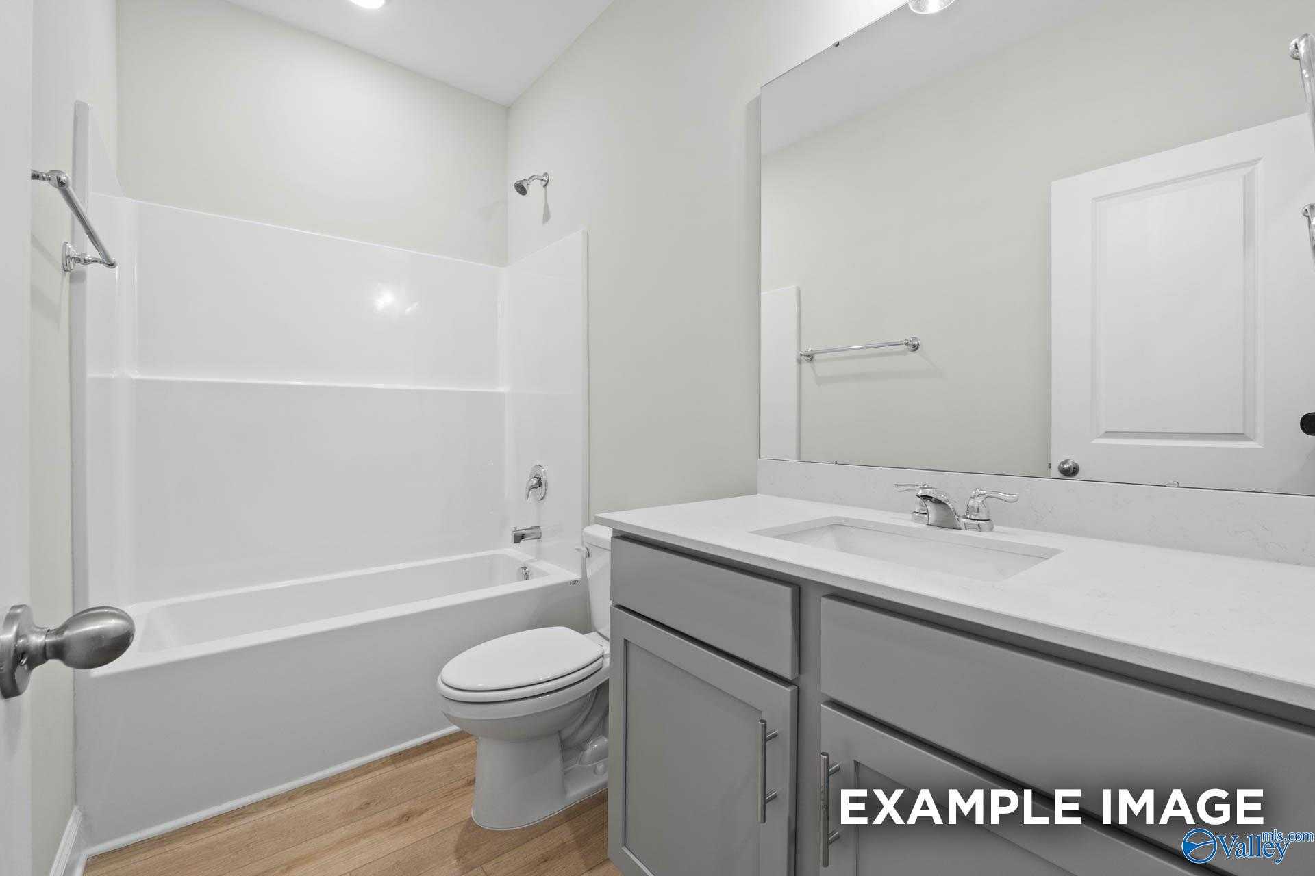 Bright bathroom with tub-shower combo, single vanity, and toilet in Davidson Homes The Franklin V, Chapel Hill, Athens, Alabama