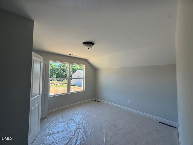 Bright bedroom with large windows overlooking trees and fields, gray walls, in The Ash B 4-bedroom home by Davidson Homes, Zebulon, NC