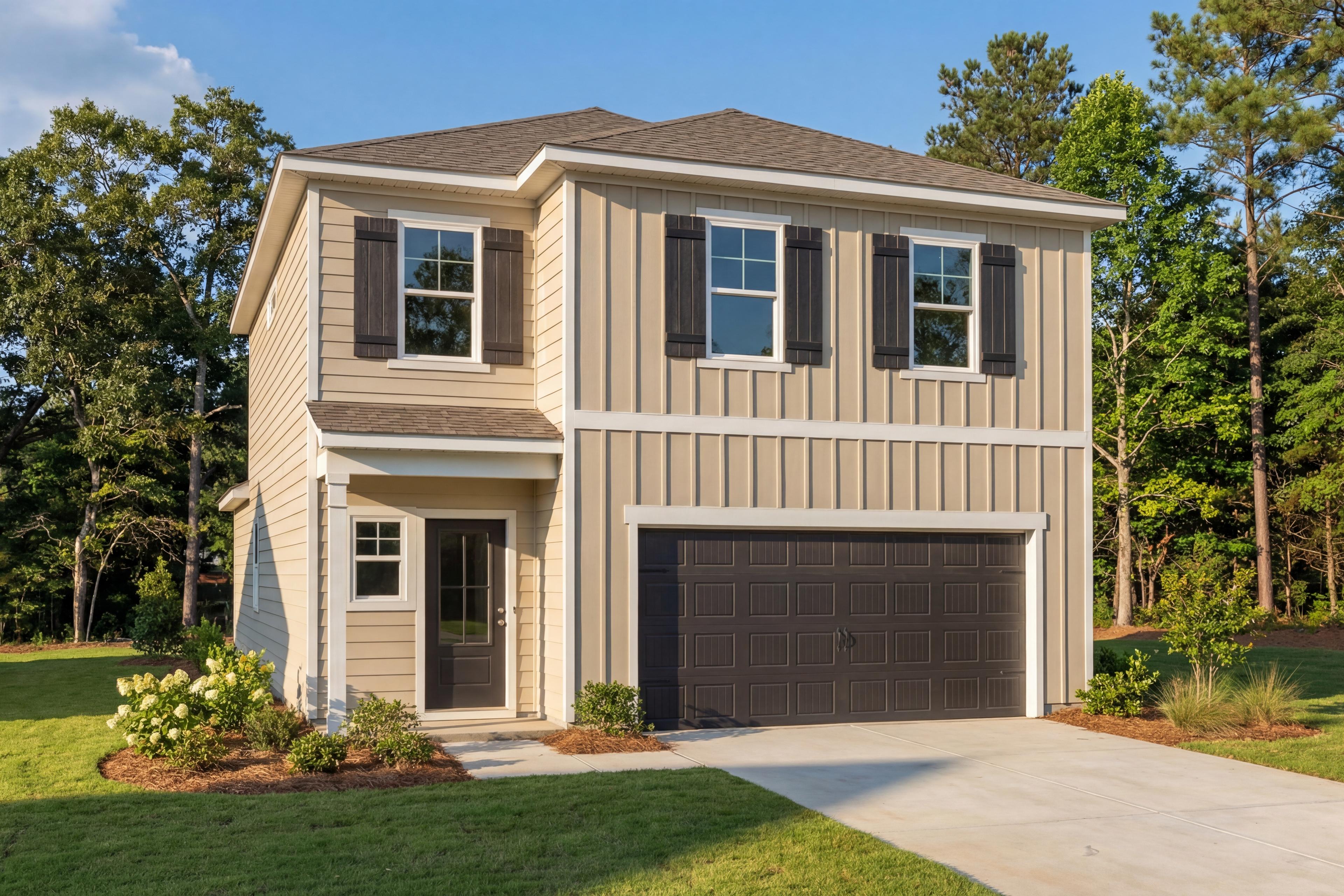 Two-story Meadowbrook A home elevation by Davidson Homes with beige siding, dark garage, front porch, hydrangeas, and pine trees in New Market AL