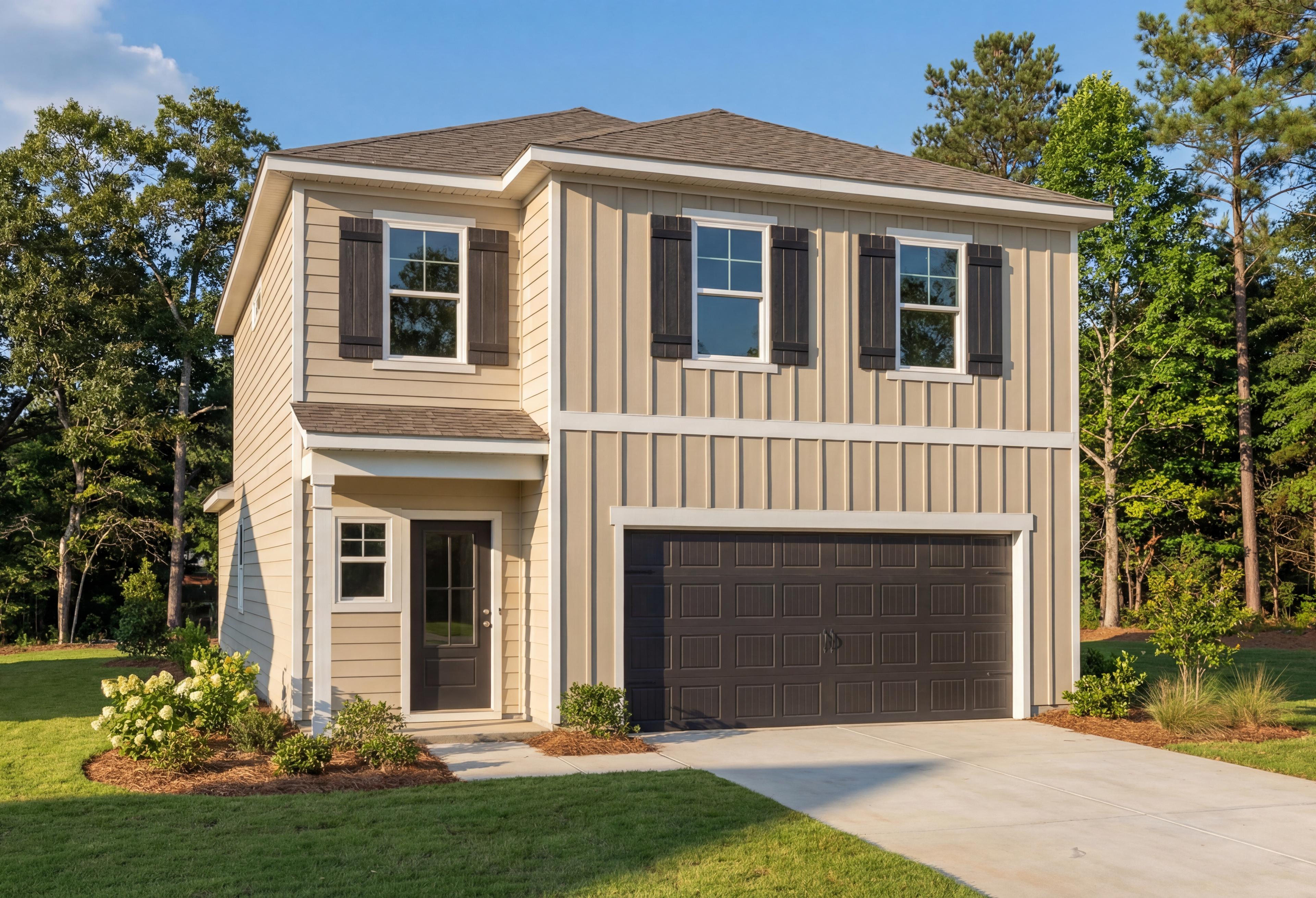 Two-story Meadowbrook A home elevation by Davidson Homes with beige siding, dark garage, front porch, hydrangeas, and pine trees in New Market AL