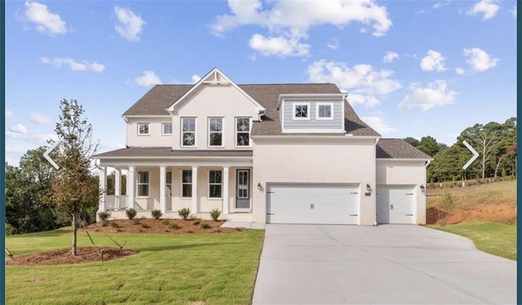 Elegant 3-story white home with wrap-around porch, 3-car garage, and lush landscaping in Melody Lakeside Estates, Buford, Georgia