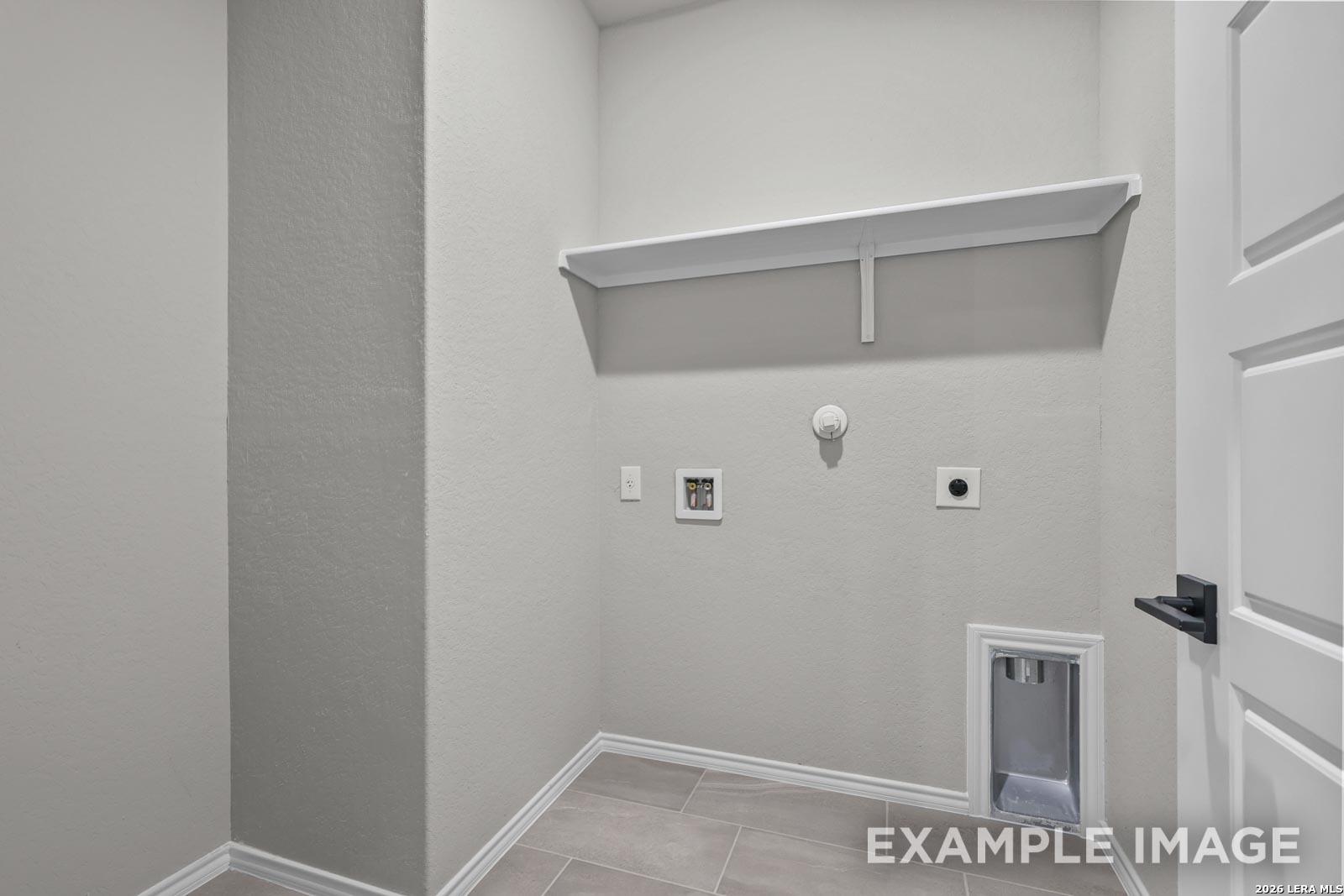 Laundry room with washer connections and overhead storage shelf in The Glenwood E floor plan at Royal Crest, San Antonio.