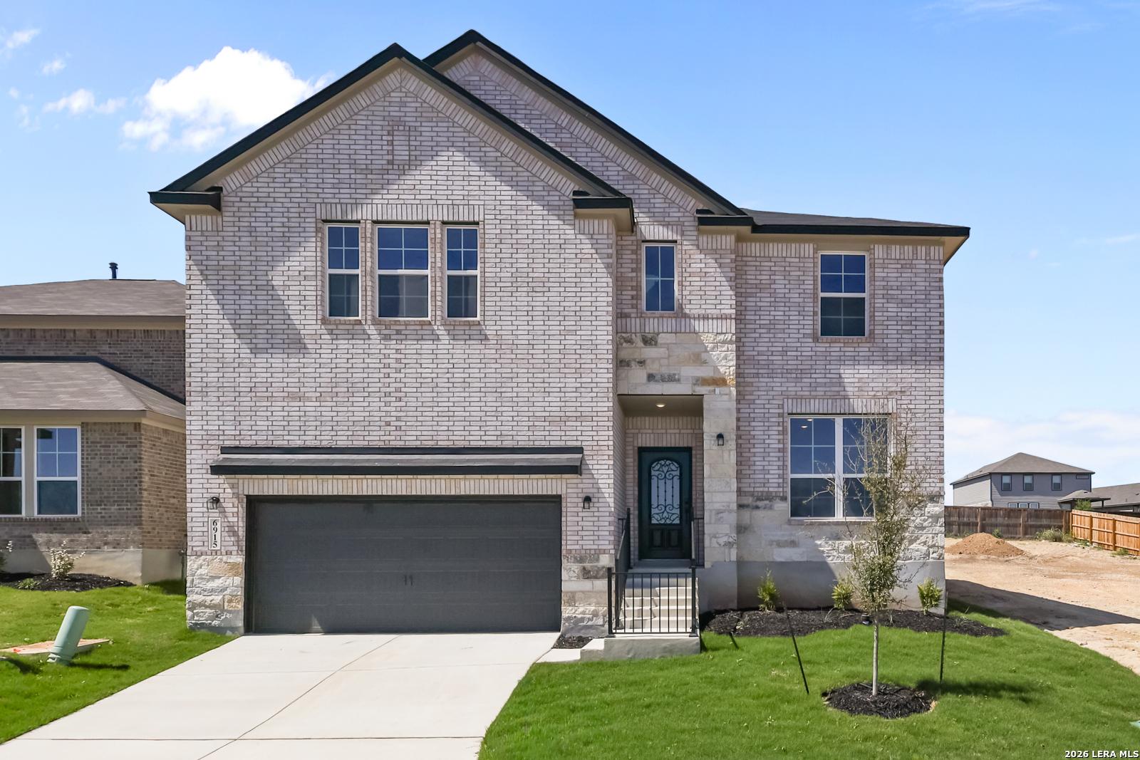 Two-story brick home with 2-car garage and front porch in Comanche Ridge, San Antonio, Texas – Davidson Homes The Sequoia B