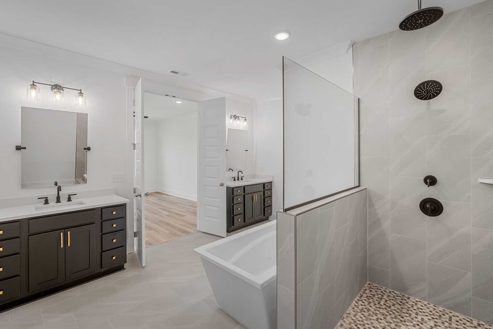 Luxurious master bathroom with double vanity, freestanding tub, and pebble-tile walk-in shower in Davidson Homes The Hathaway, Murfreesboro, TN