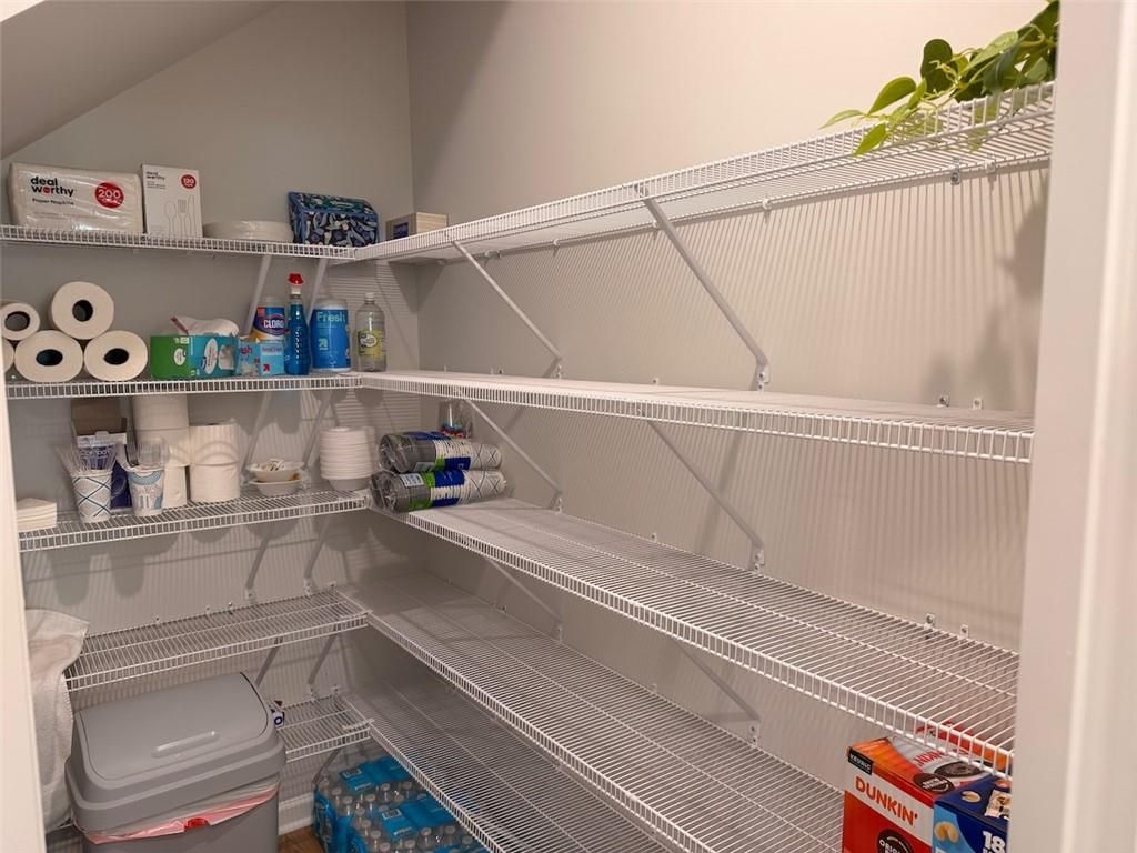 Spacious walk-in pantry with white wire shelving stocked with household supplies in Davidson Homes Pinecrest J, Cartersville GA