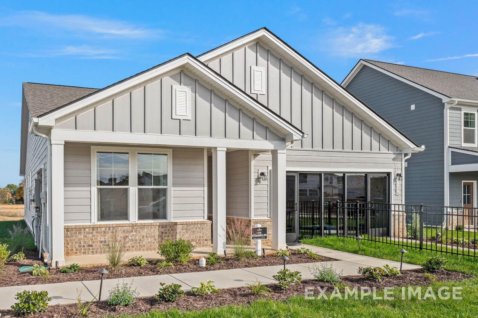 Modern 1-story gray home with board-and-batten siding, covered porch, 2-car garage in Sage Farms, White House, TN - Davidson Homes Franklin B