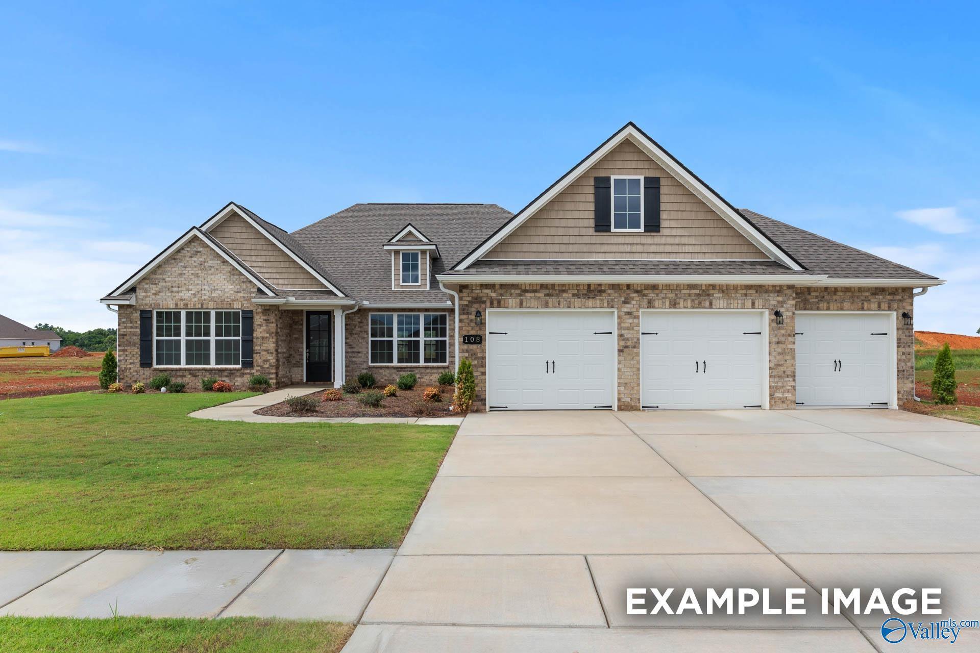 Modern two-story Emory floor plan home with brick facade, 3-car garage, and manicured lawn in Kendall Farms, Toney, Alabama
