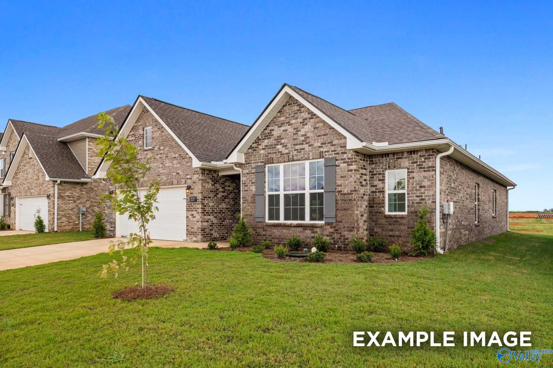 Brick single-story home with 2-car garage, shuttered windows, and landscaped yard in Cain Park, Hartselle, Alabama