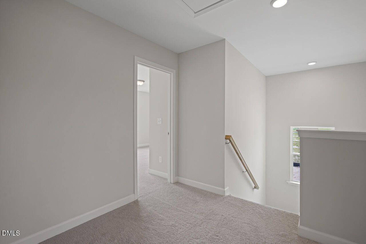 Bright second-floor carpeted landing in The Chestnut floor plan by Davidson Homes at Wendell Ridge, Wendell, NC.