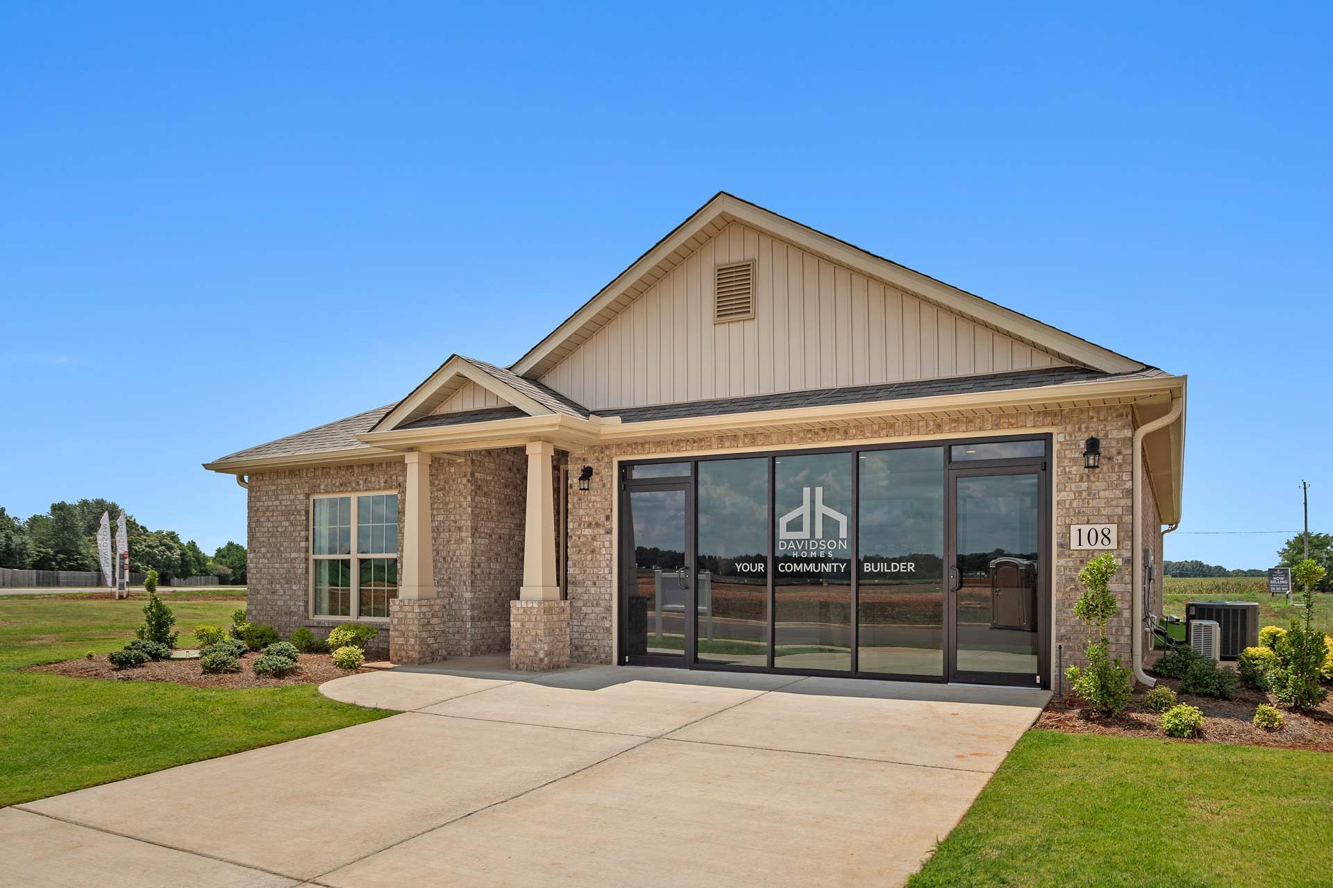Davidson Homes model home exterior at Heritage Lakes in New Market Alabama with brick base siding and glass entry