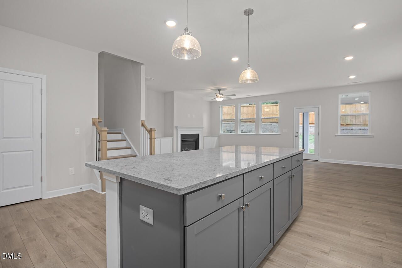 Modern kitchen island with granite countertops in The Ashport G floor plan at Sage on North Main, Wake Forest, NC.