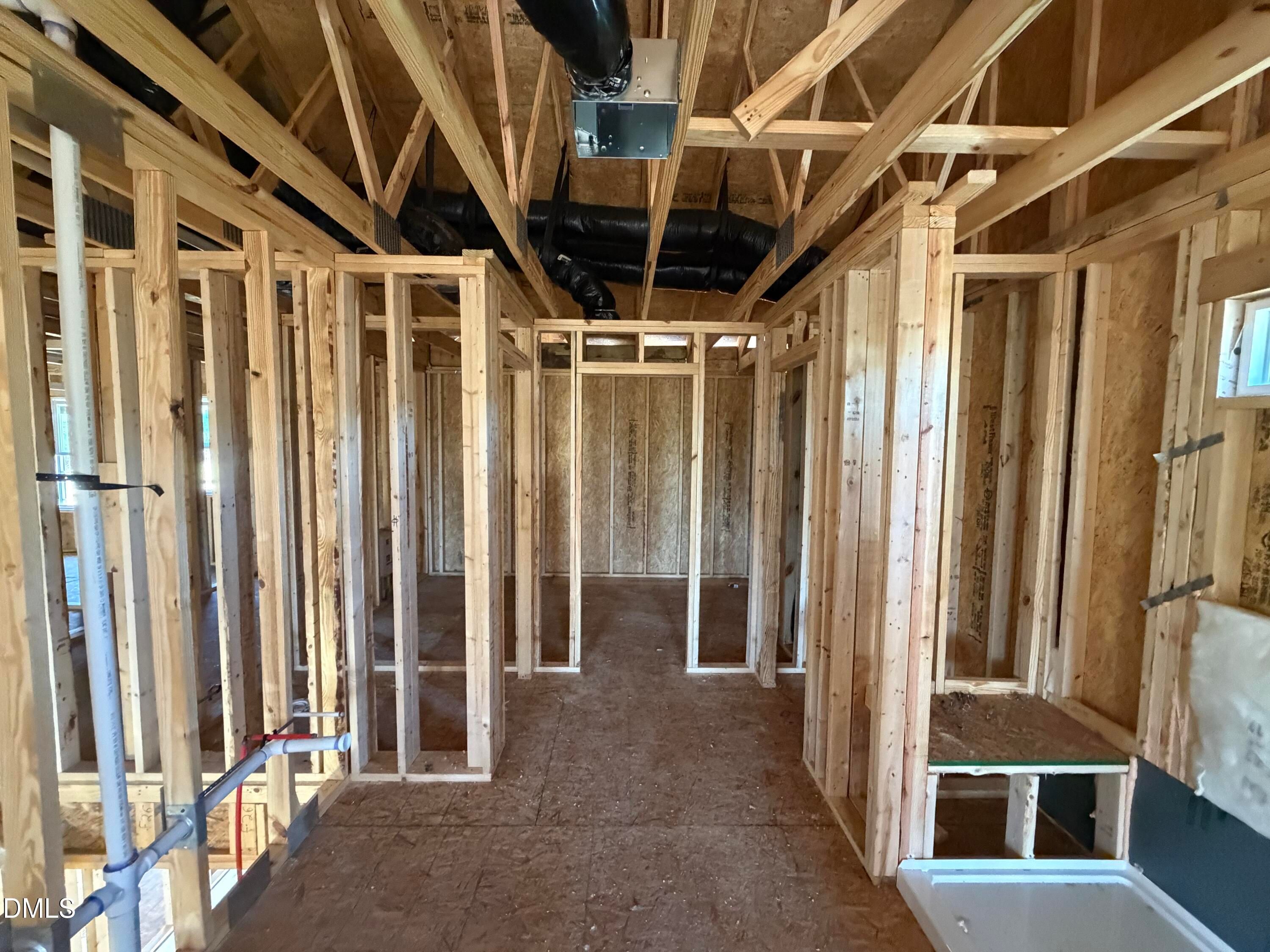 Exposed wooden framing, HVAC ducts, and shower base in bathroom construction of Davidson Homes Hickory II B in Lillington, NC