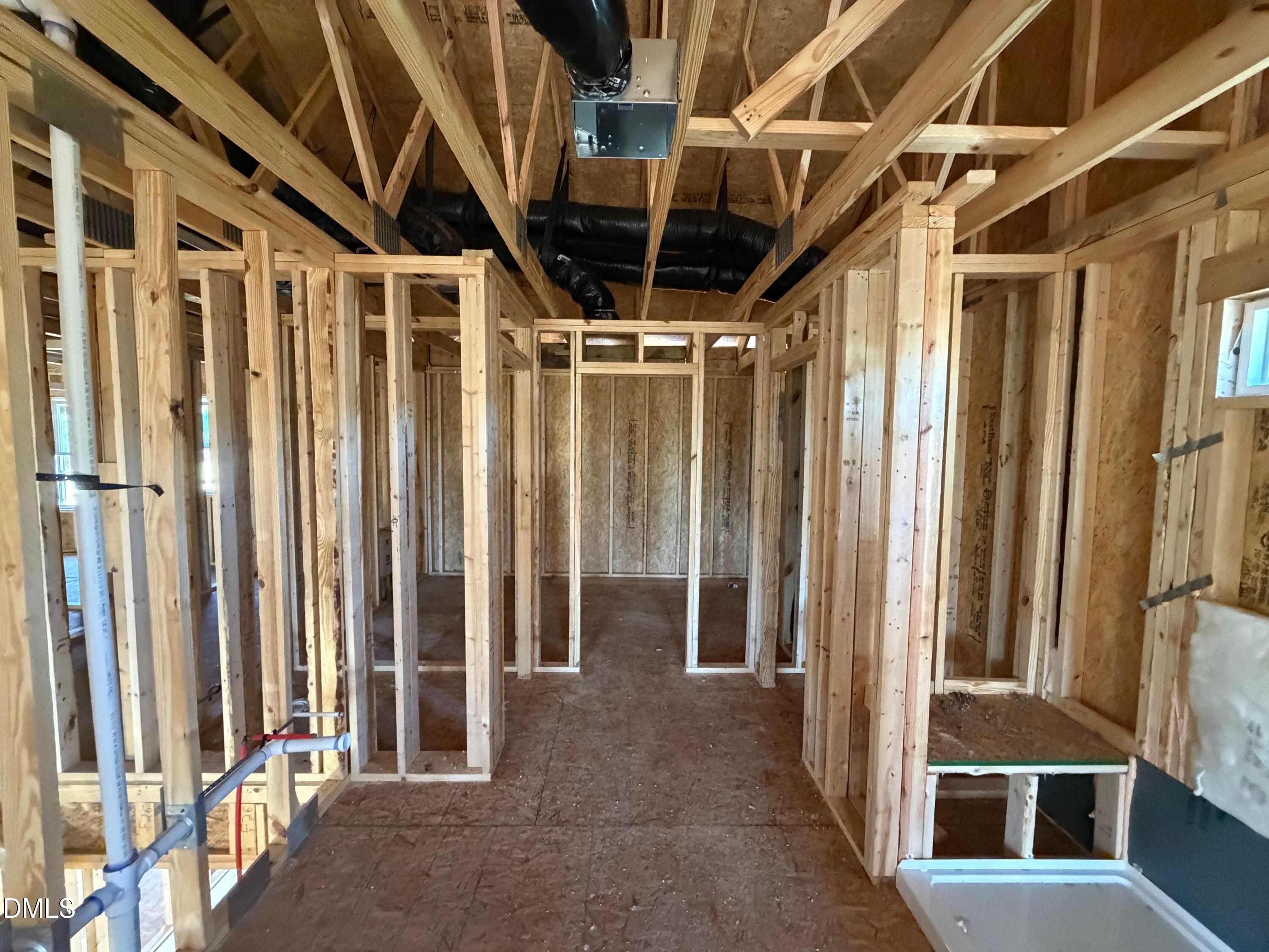 Exposed wooden framing, HVAC ducts, and shower base in bathroom construction of Davidson Homes Hickory II B in Lillington, NC