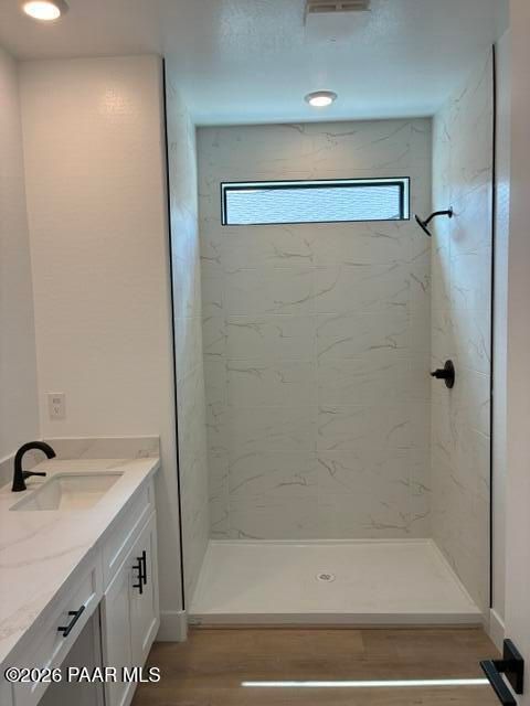 Modern walk-in shower with marble tile and vanity in bathroom at Davidson Homes Durango II G, Prescott, Arizona
