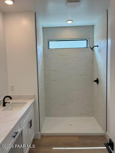 Modern walk-in shower with marble tile and vanity in bathroom at Davidson Homes Durango II G, Prescott, Arizona