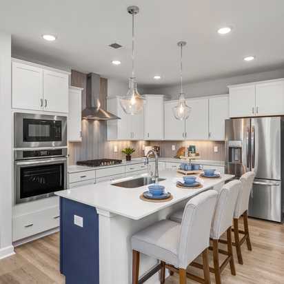 Spacious modern kitchen in Summers Walk Davidson NC with white cabinetry island seating stainless appliances hardwood floors