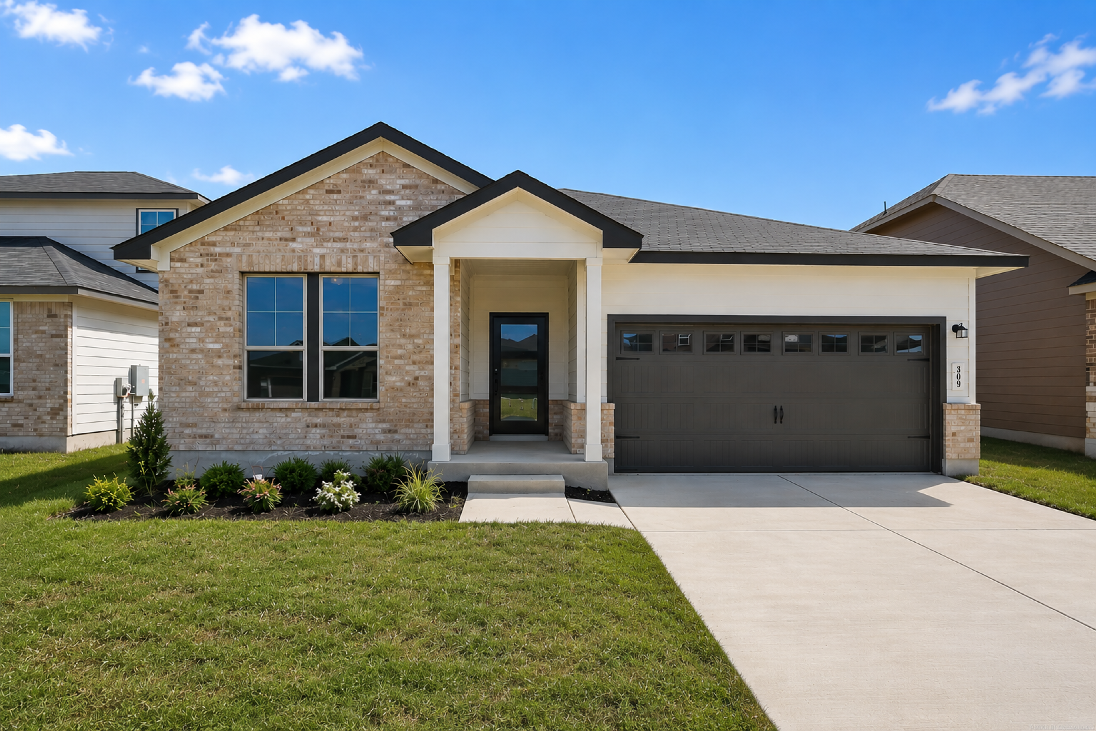 Modern kitchen with dark cabinets, granite island, stainless steel appliances at Hannah Heights in Seguin, Texas