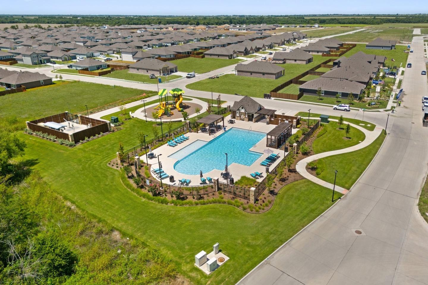 Resort-style pool and playground at Waverly Estates in Josephine TX with lounge chairs, pavilion and walking paths