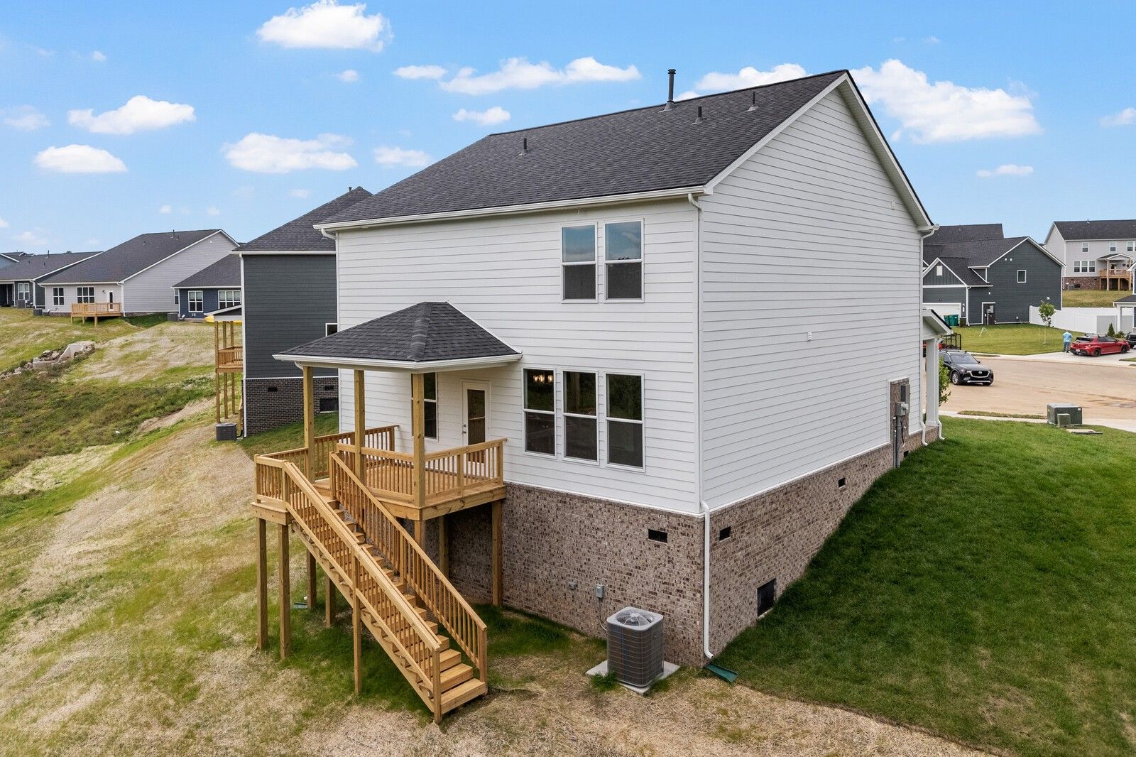 Two-story The Logan C home with elevated wood deck in Calista Farms, White House, Tennessee.