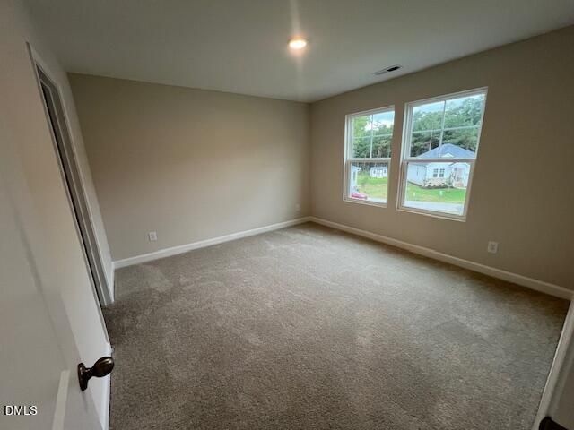 Spacious carpeted bedroom with natural light and neighborhood views in Davidson Homes The Willow D, Wellers Knoll, Lillington, NC