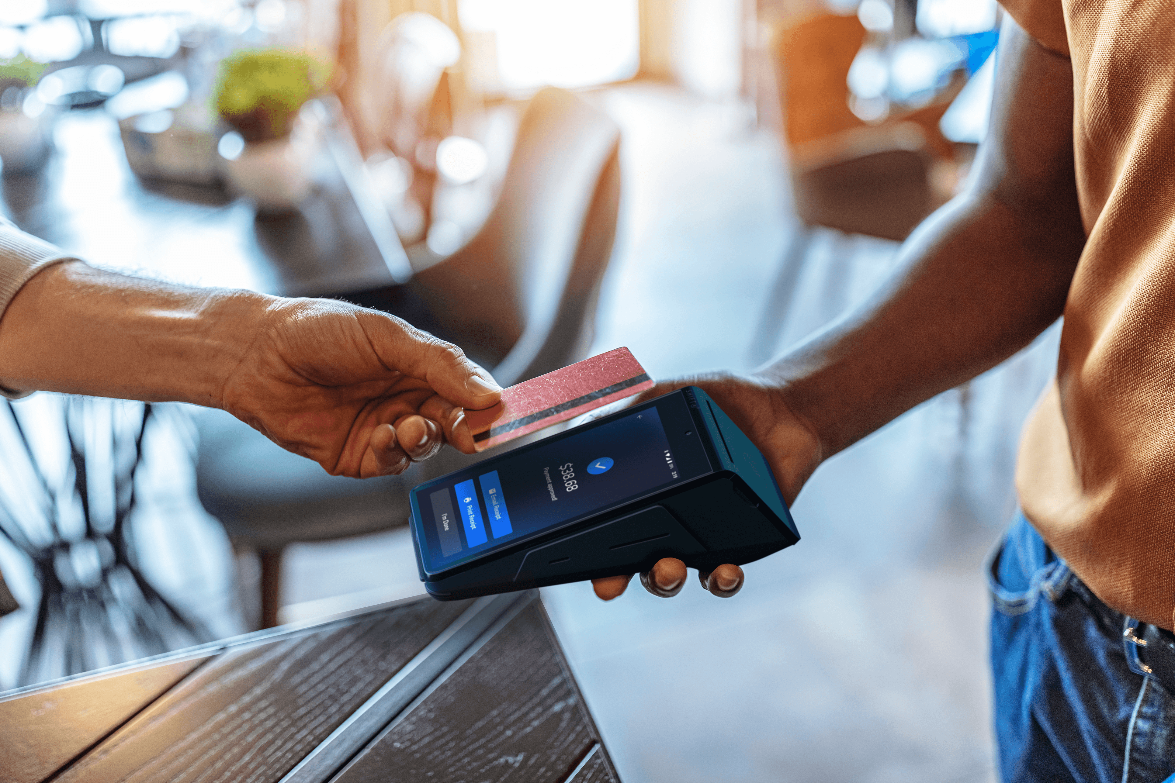 Person paying with tap-to-pay on a SkyTab Mobile POS device - POS pricing - SkyTab