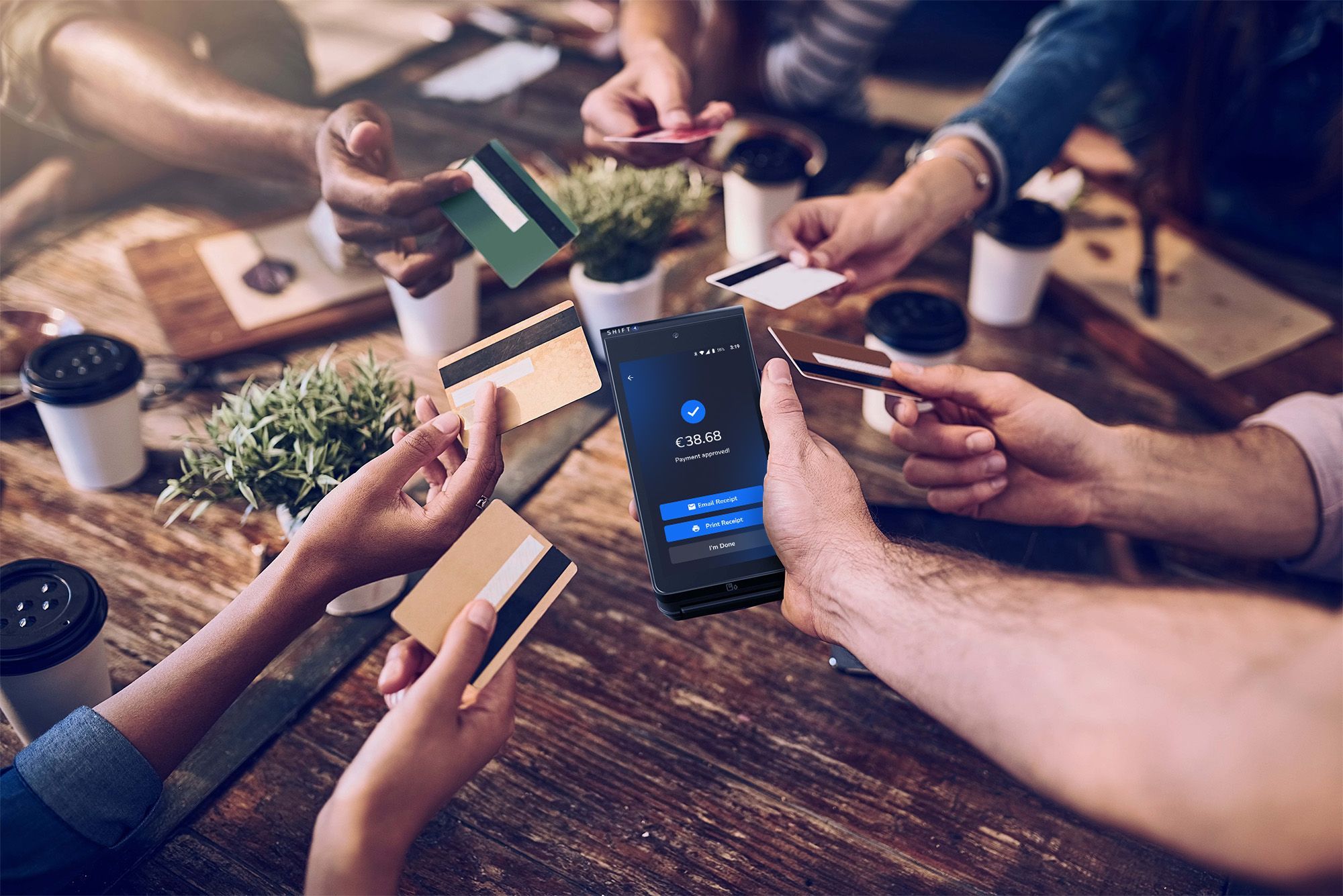 Group of restaurant customers offering their credit cards to pay on a SkyTab Mobile POS device - mobile ordering and payments - SkyTab