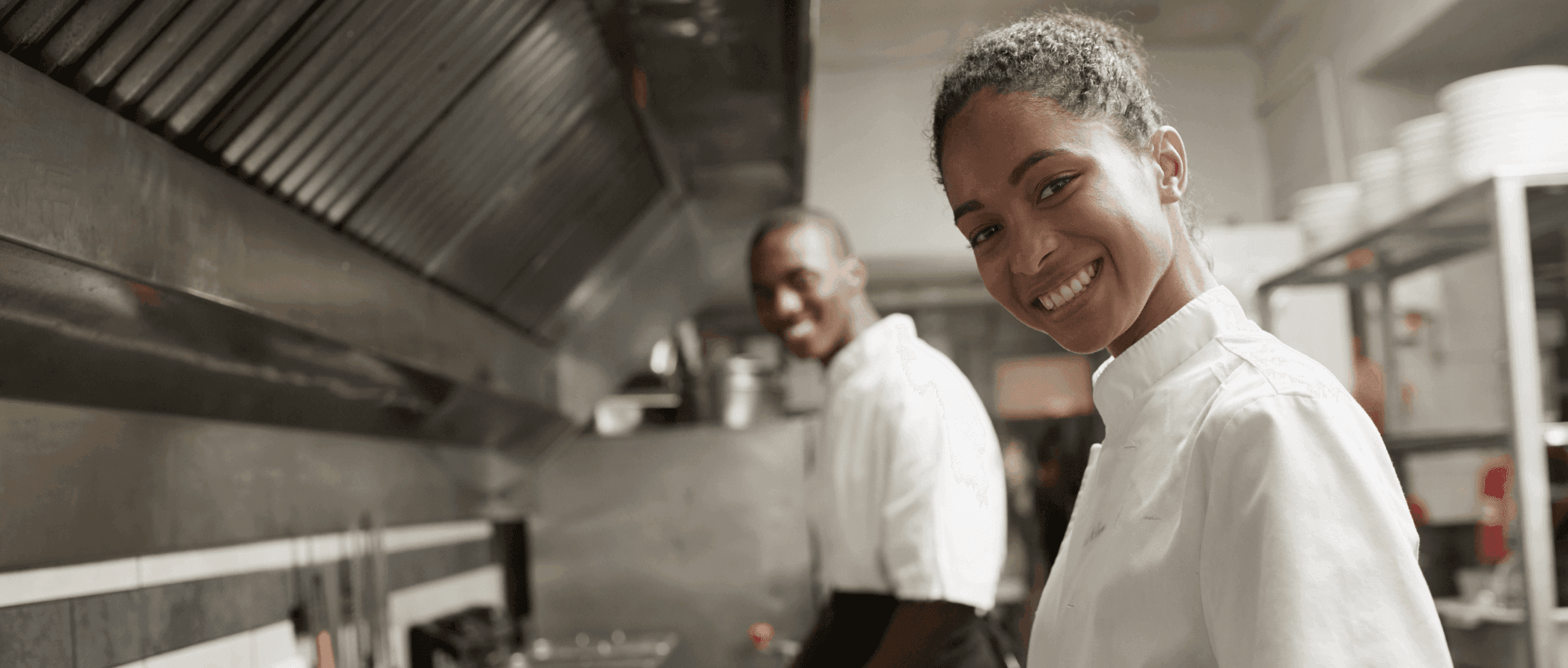 Two chefs in a kitchen smiling - restaurant POS system - SkyTab
