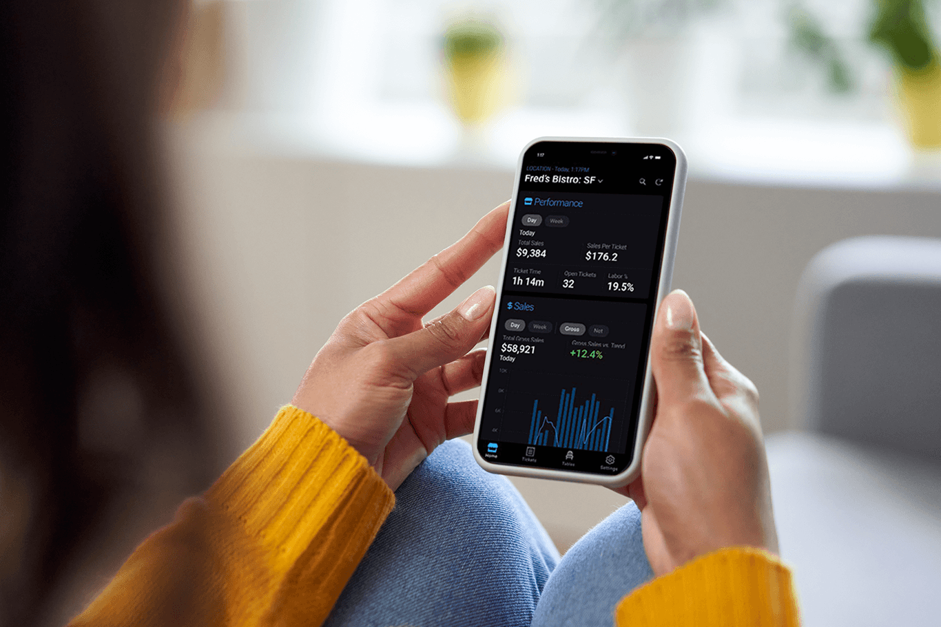 Person holding a smartphone showing the InCharge mobile app - enterprise POS system - SkyTab