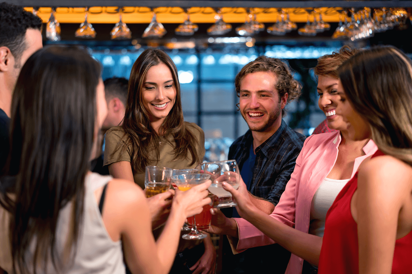 Six smiling people holding drinks in a bar - restaurant POS system - SkyTab