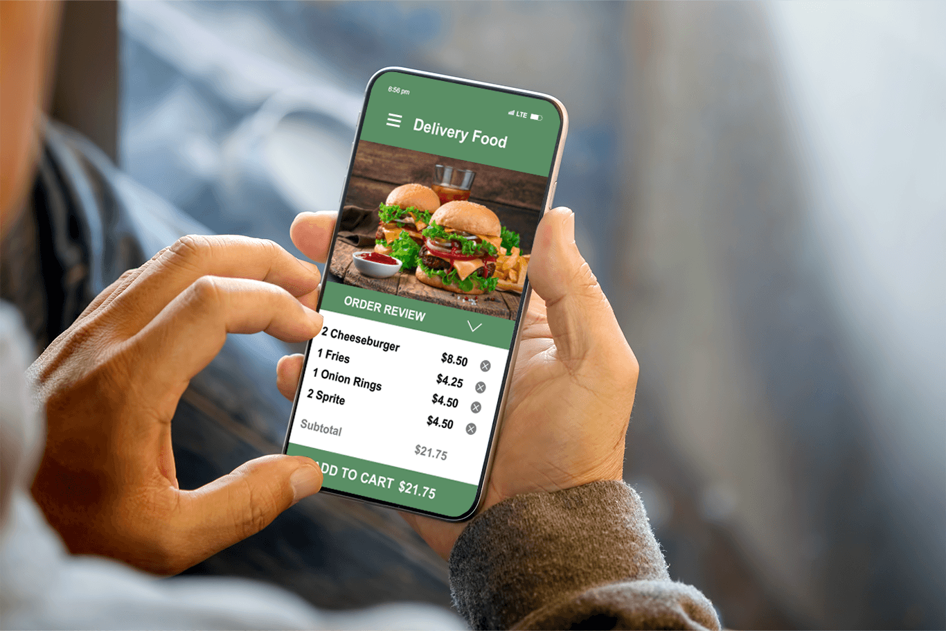 Man holding a phone showing a screen of an online order for burgers - quick service POS system - SkyTab