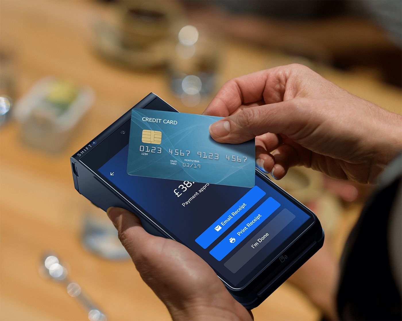 A close up of a SkyTab mobile POS device with a customer tapping their credit card for payment - restaurant POS system - SkyTab