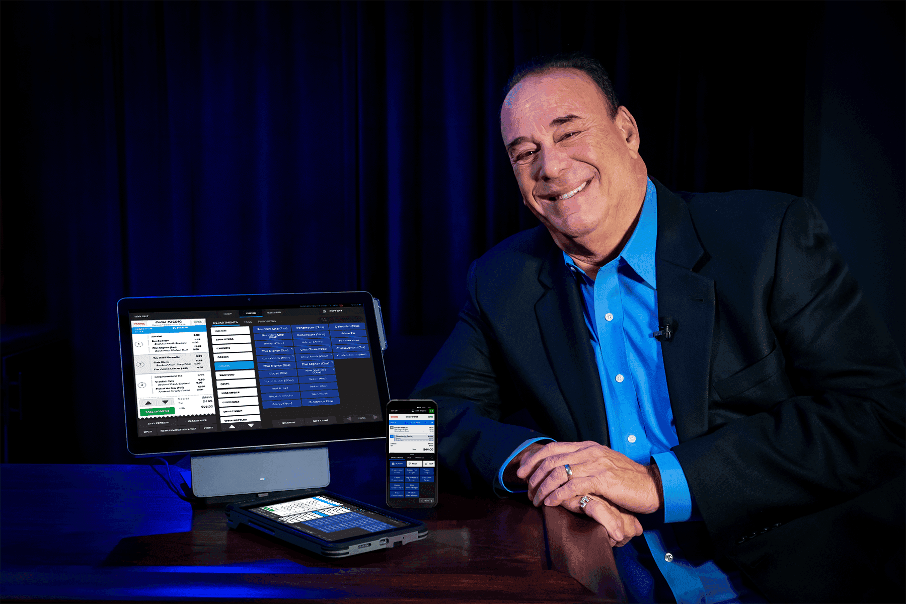 Jon Taffer standing next to a SkyTab POS system, SkyTab Air, and SkyTab Glass - restaurant POS system - SkyTab