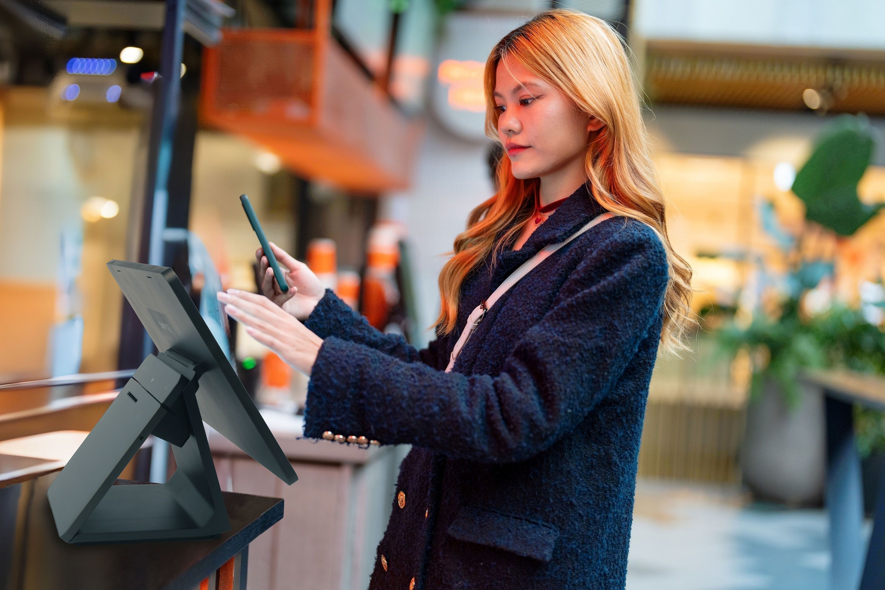 Woman using a SkyTab Kiosk POS system - SkyTab