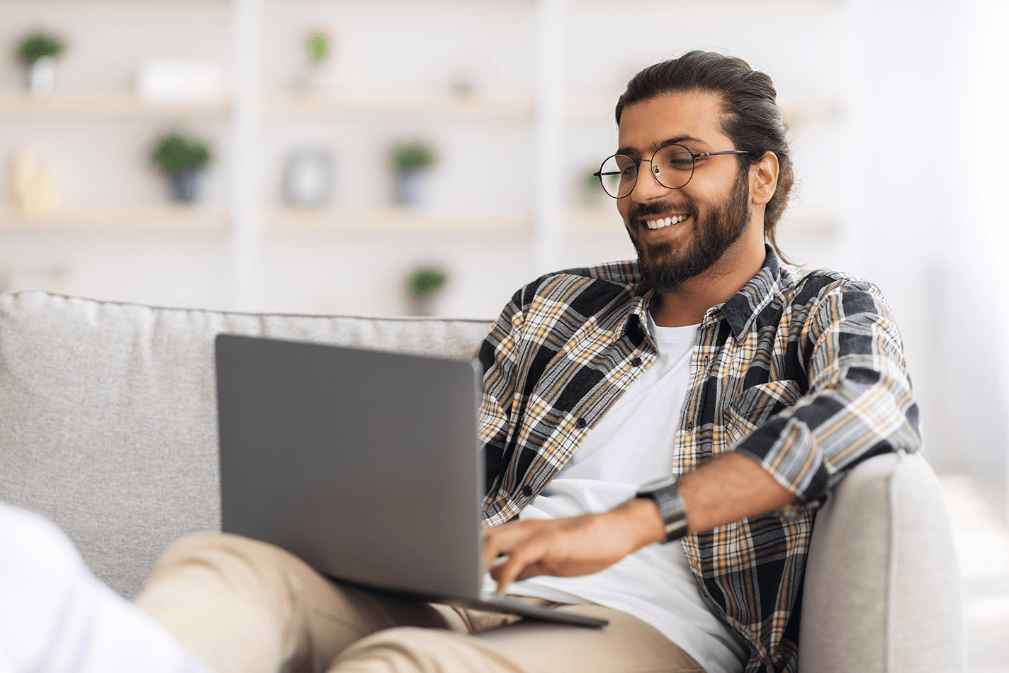 Man smiling at his laptop - build a restaurant website - Shift4 Dine