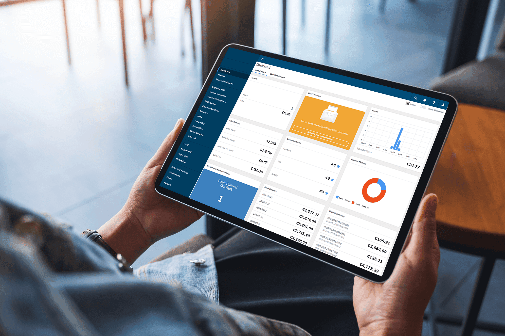 Person holding a tablet showing the Shift4 Dine Customer Hub dashboard - POS features - Shift4 Dine