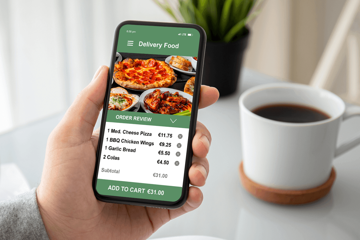 Man holding a phone showing a screen of an online order for pizza and wings - pizza POS system - Shift4 Dine