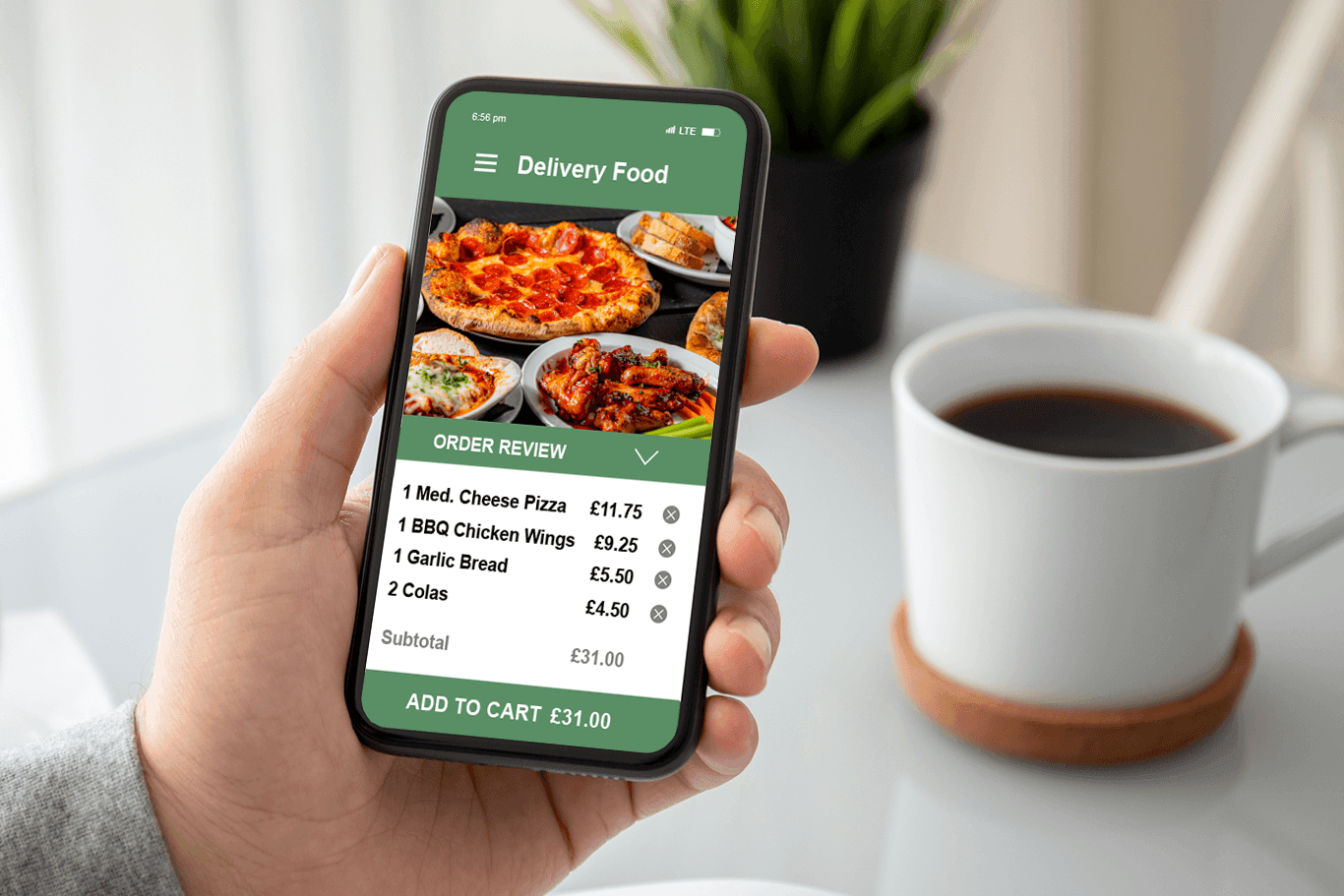 Man holding a phone showing a screen of an online order for pizza and wings - pizza POS system - Shift4 Dine