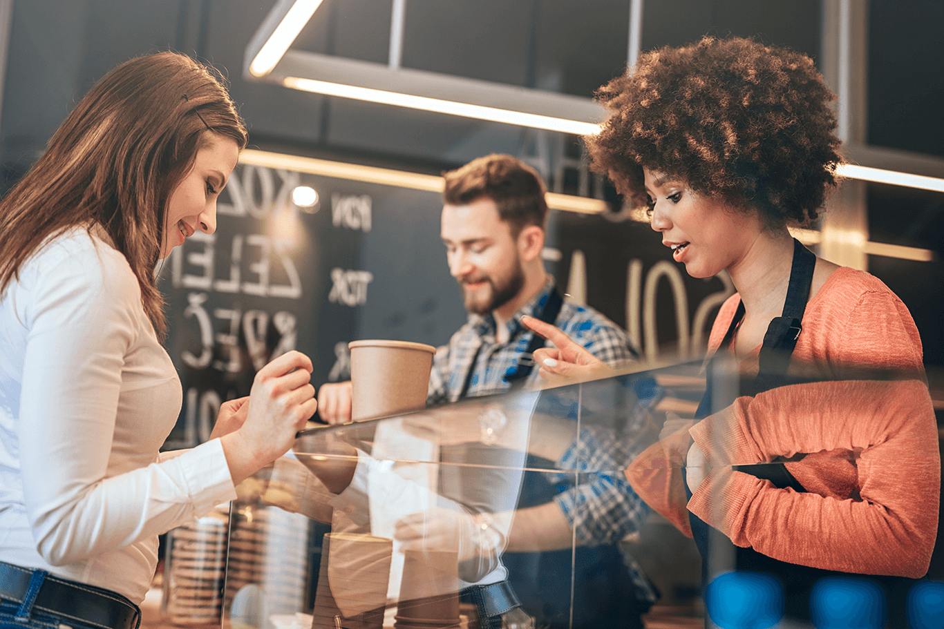 Two restaurant employees serving a customer - restaurant POS system - Shift4 Dine