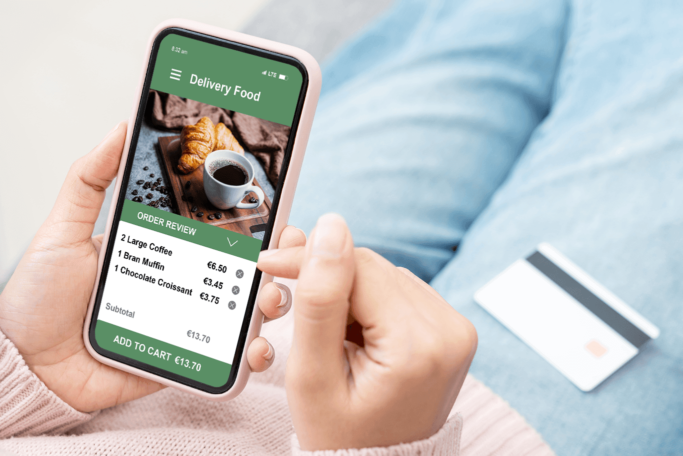 Woman holding a phone showing a screen of an online order for coffee - coffee shop POS system - Shift4 Dine