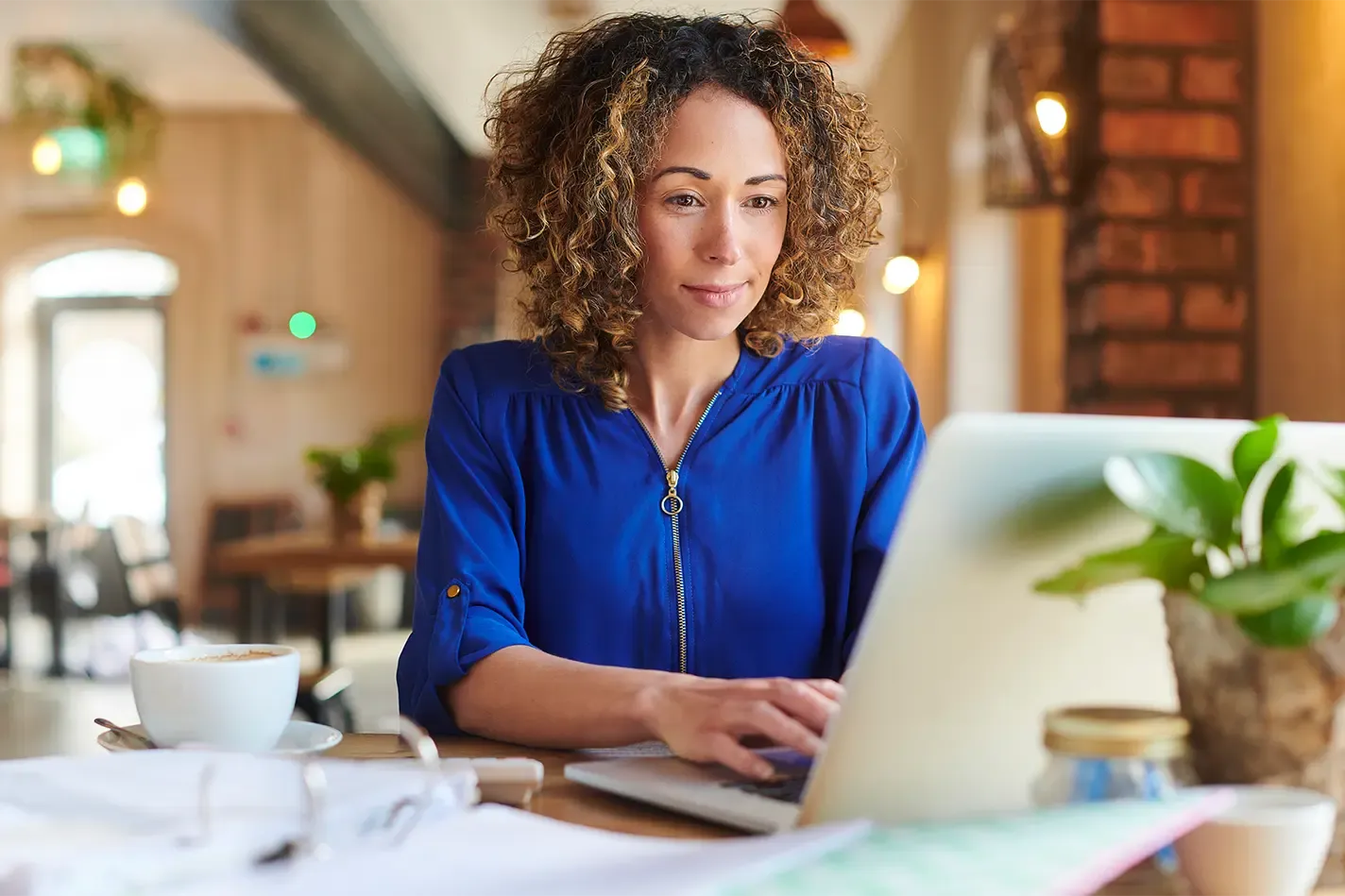 Woman on laptop - crypto POS system - Shift4 Dine