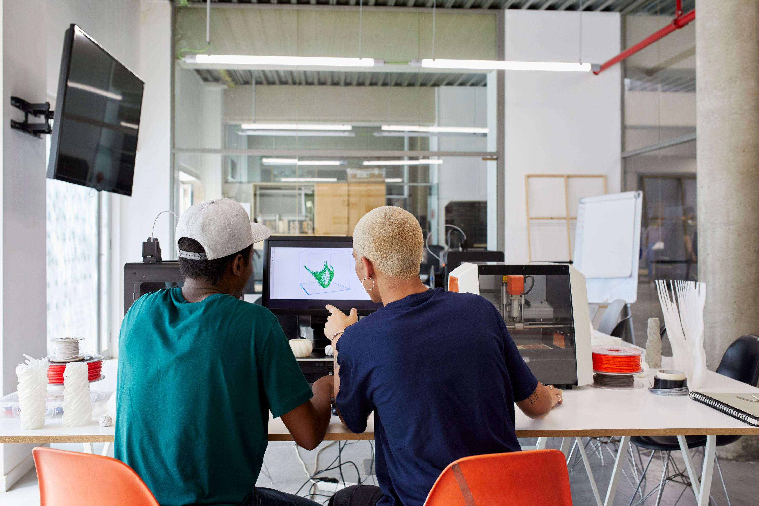 Woman writing code at a desk and smiling