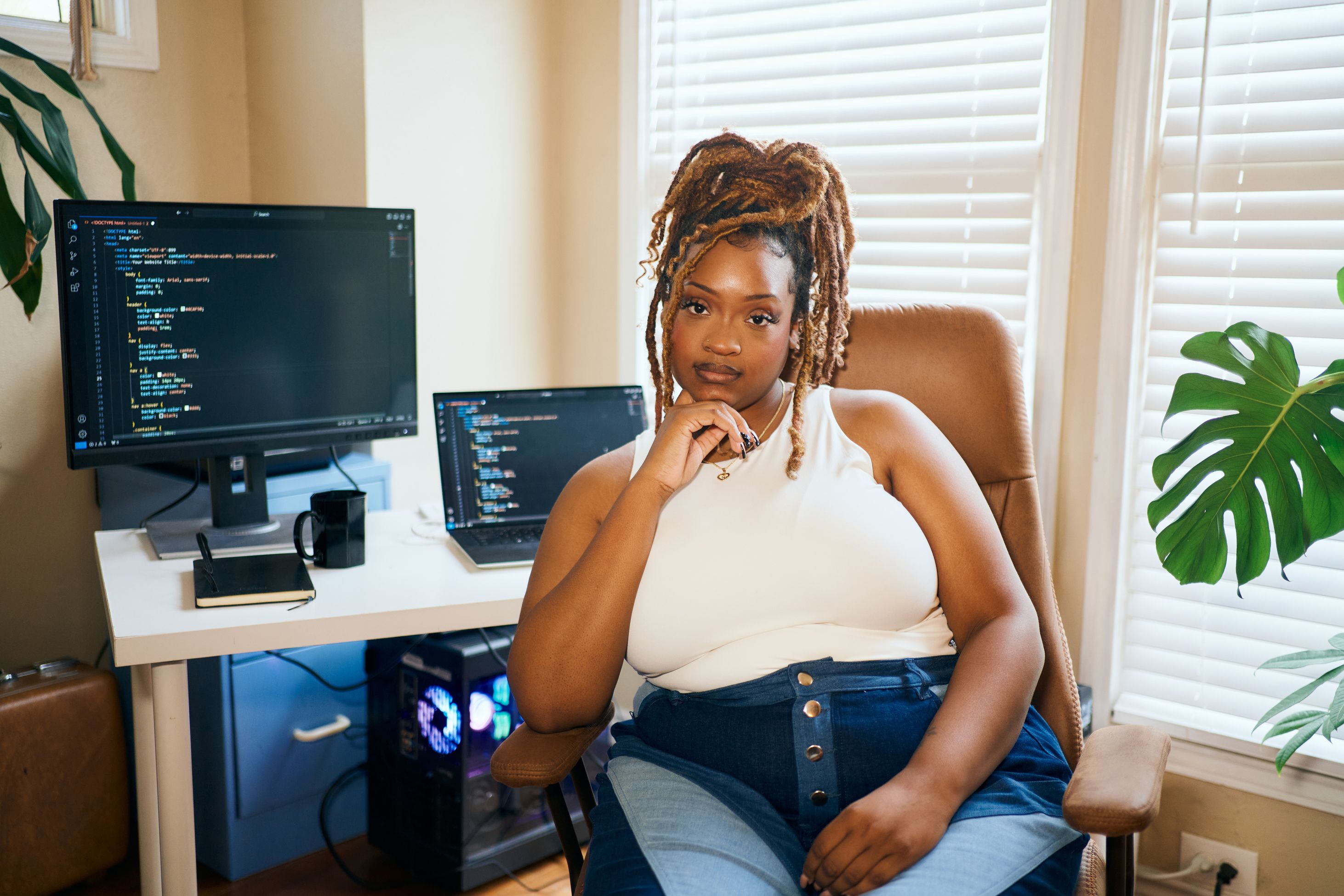 woman sitting in front of a desk looking directly at the camera