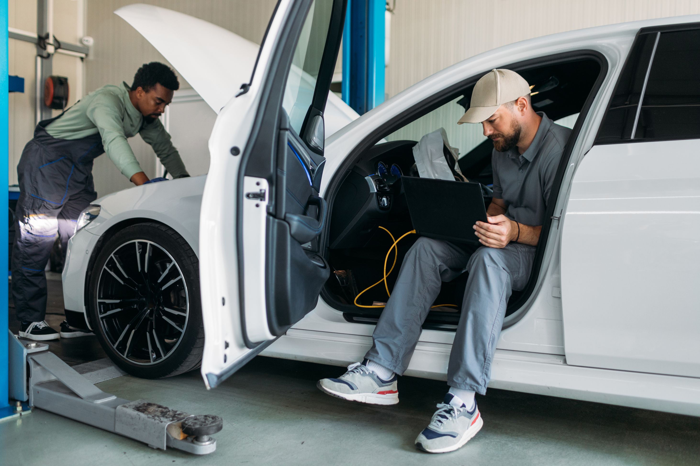 Two men fixing a car