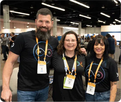 Three people taking a picture at an event