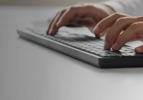Person typing on keyboard