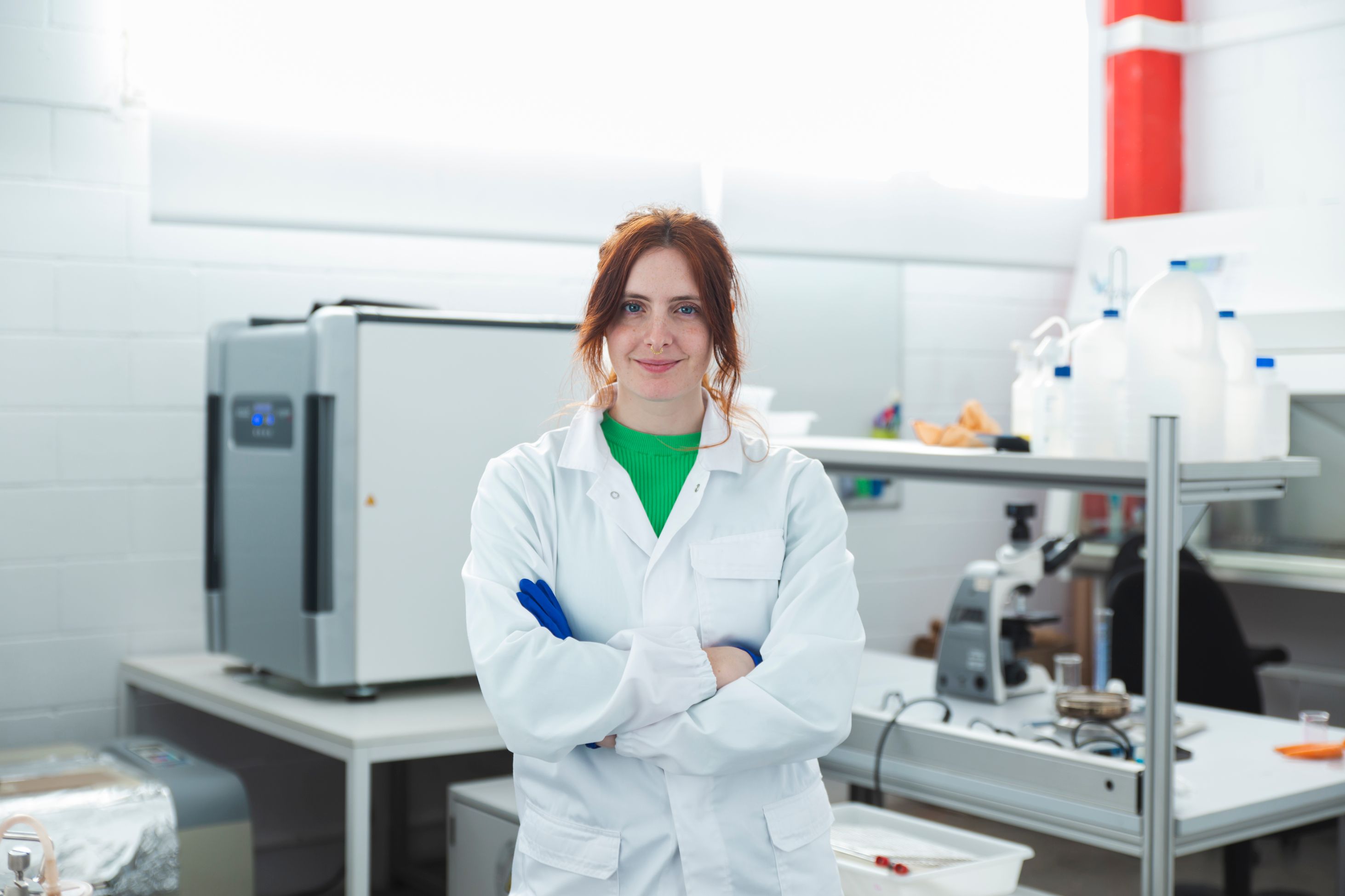 woman smiling in a bio lab